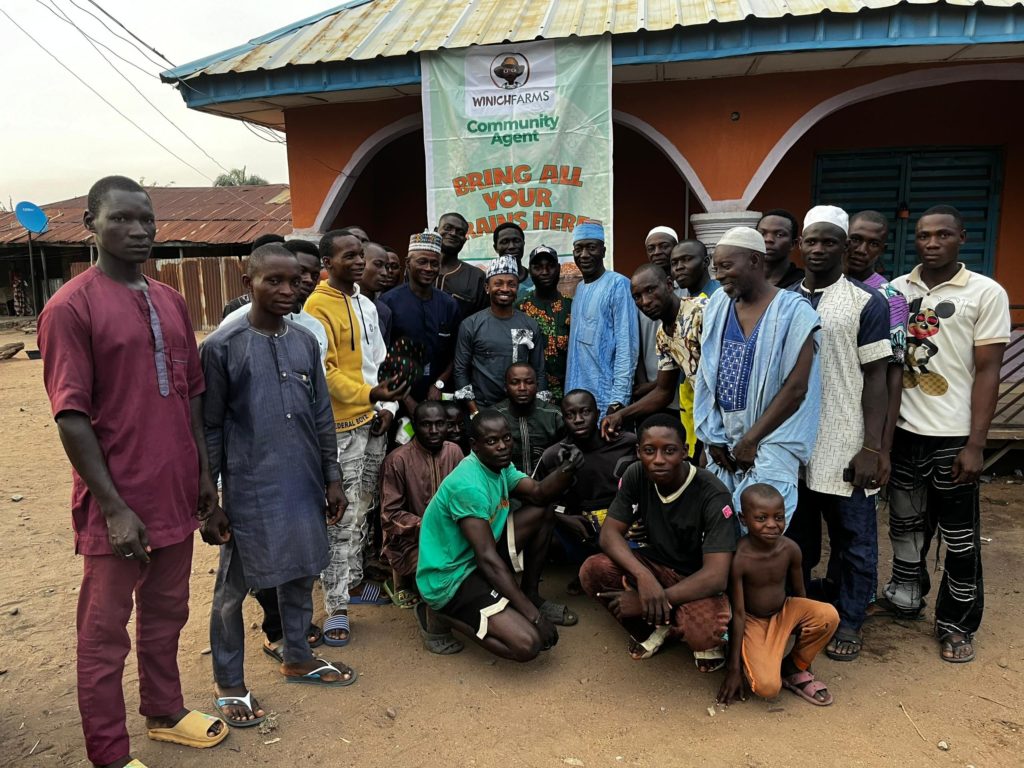 Farmers pose in front of a collection point operated by Winich Farms